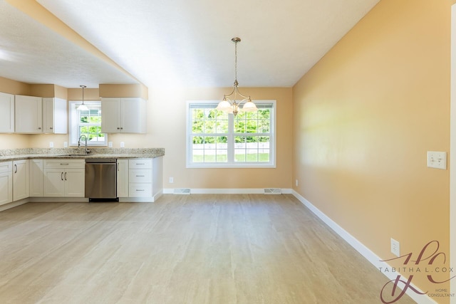 9379 Cook St, Montague, MI 49437 - kitchen featuring stainless steel dishwasher, a sink, light wood-style flooring, and baseboards