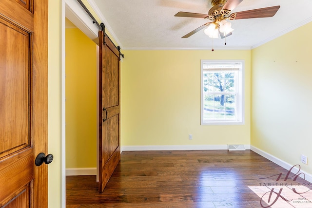 9379 Cook St, Montague, MI 49437 - unfurnished bedroom with a barn door, dark wood-type flooring, crown molding, baseboards, and a ceiling fan