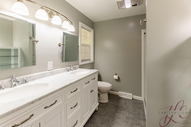 9379 Cook St, Montague, MI 49437 - full bath featuring double vanity, toilet, baseboards, and tile patterned flooring