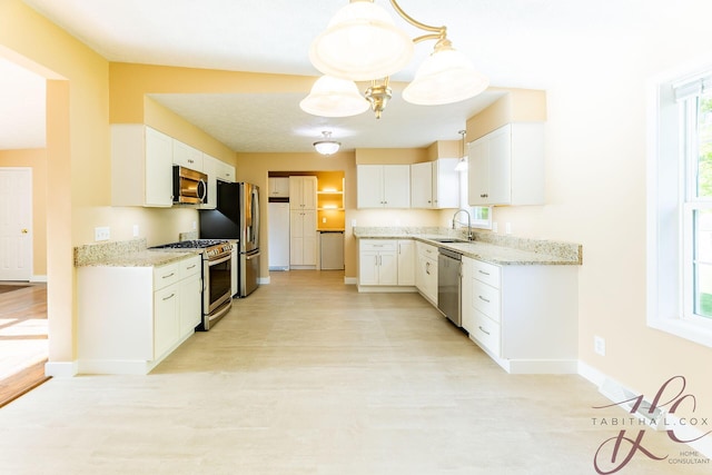 9379 Cook St, Montague, MI 49437 - kitchen featuring stainless steel appliances, baseboards, a sink, and healthy amount of natural light