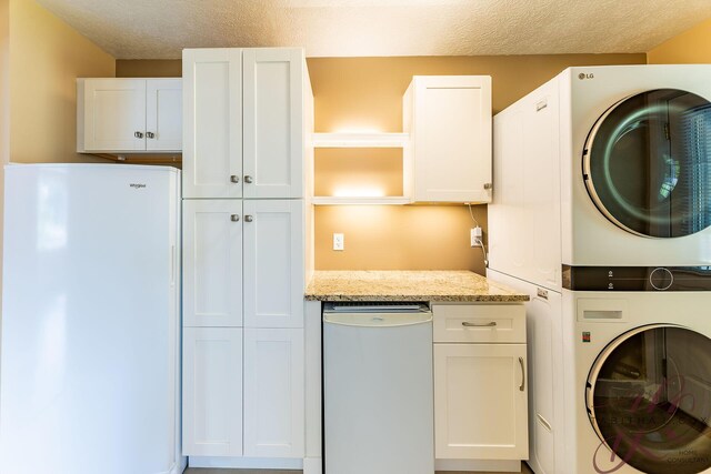 9379 Cook St, Montague, MI 49437 - washroom featuring stacked washer / dryer and a textured ceiling