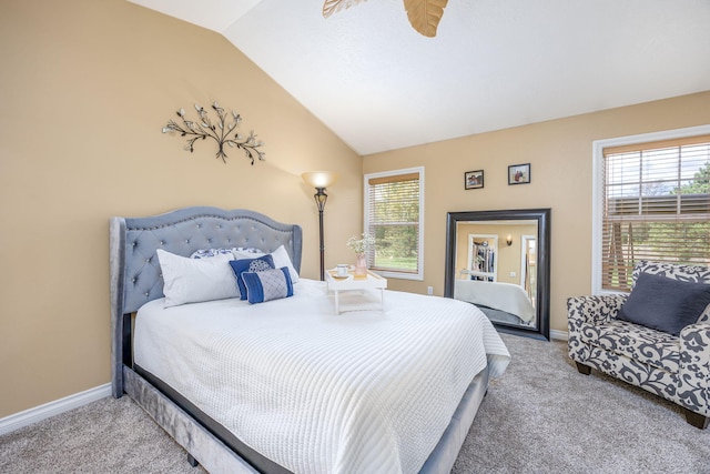 bedroom featuring lofted ceiling, multiple windows, baseboards, and carpet
