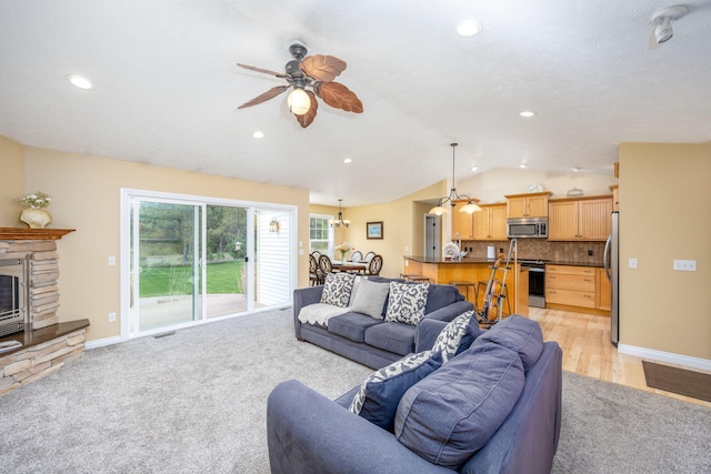 living room featuring lofted ceiling, visible vents, recessed lighting, a ceiling fan, and baseboards
