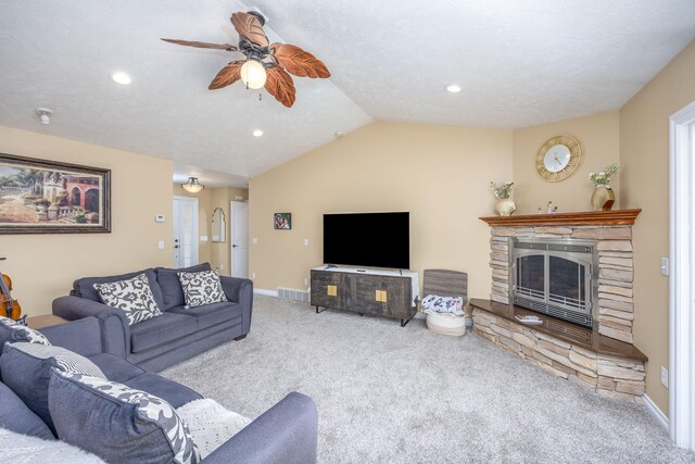carpeted living area with baseboards, a stone fireplace, ceiling fan, lofted ceiling, and recessed lighting