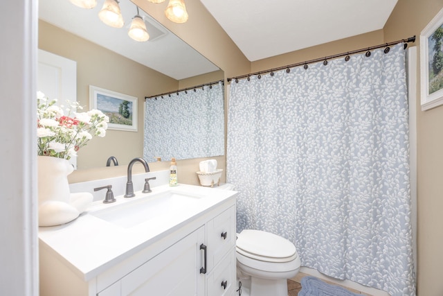 bathroom featuring toilet and vanity