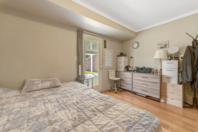 bedroom featuring access to exterior, ornamental molding, and light wood finished floors