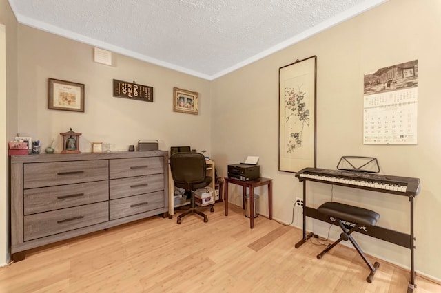 office space with wood finished floors, a textured ceiling, and crown molding