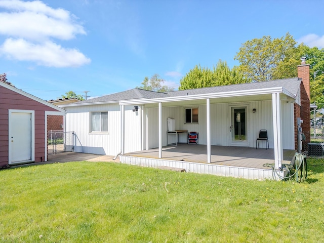 rear view of property featuring a chimney, central AC unit, a patio area, and a shingled roof
