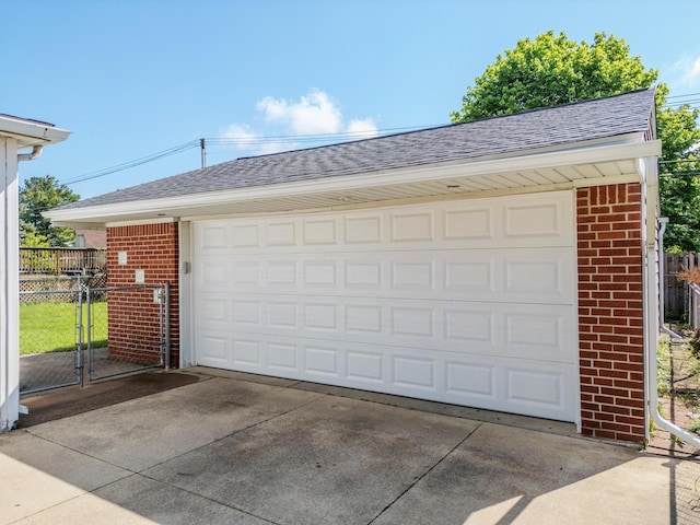 detached garage featuring fence