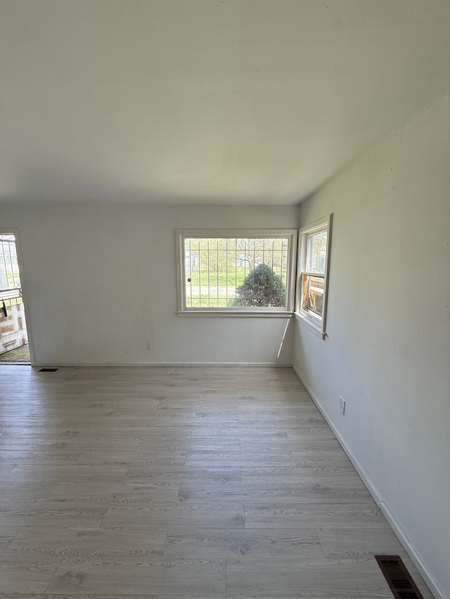 1710 Polly St, Flint, MI 48505 - spare room featuring light wood-style floors, plenty of natural light, and visible vents