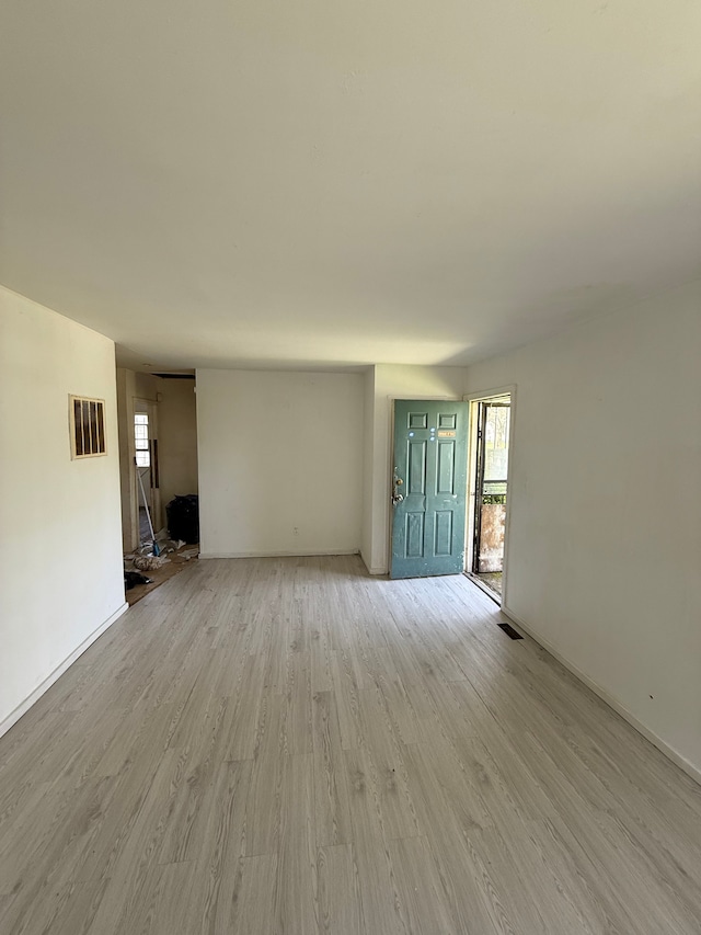 1710 Polly St, Flint, MI 48505 - unfurnished living room featuring light wood finished floors, plenty of natural light, and visible vents
