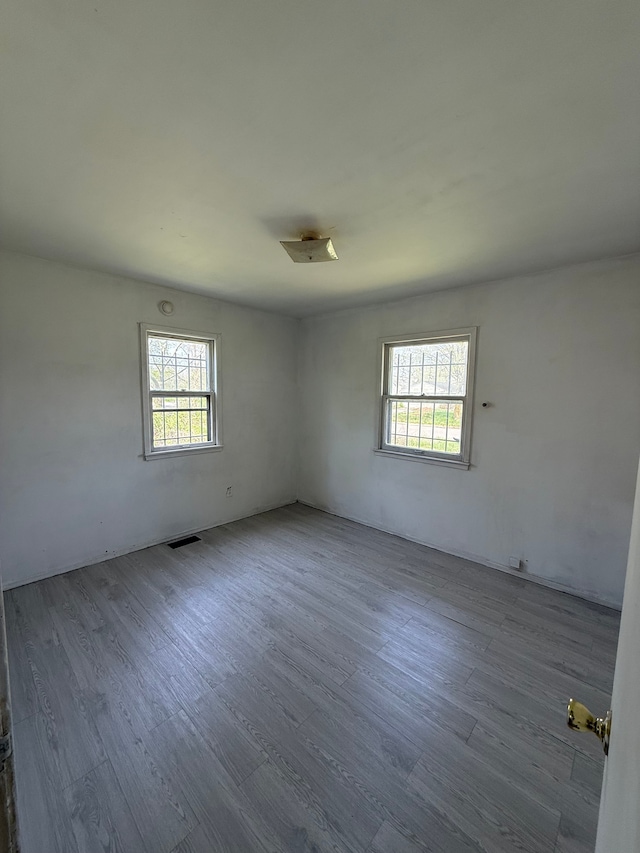 1710 Polly St, Flint, MI 48505 - spare room featuring a healthy amount of sunlight and wood finished floors