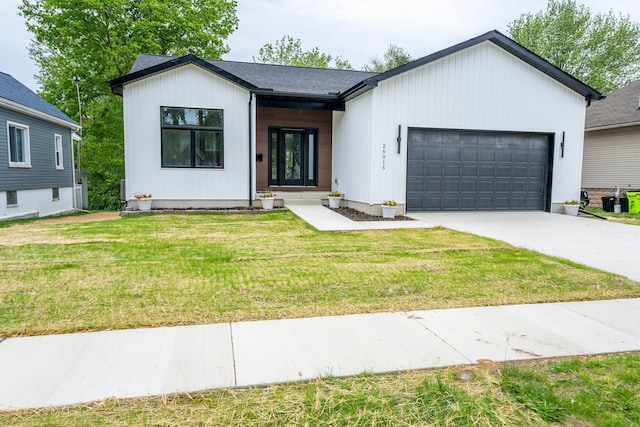 26015 E Huron River Dr, Flat Rock, MI 48134 - modern inspired farmhouse with a garage, driveway, a front yard, and roof with shingles