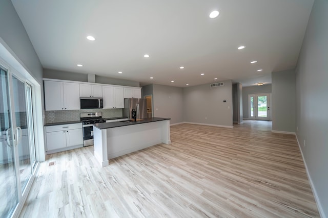 26015 E Huron River Dr, Flat Rock, MI 48134 - kitchen featuring appliances with stainless steel finishes, dark countertops, white cabinets, baseboards, and recessed lighting