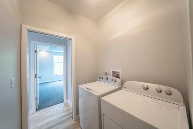 26015 E Huron River Dr, Flat Rock, MI 48134 - laundry room with separate washer and dryer, light wood-style floors, and baseboards
