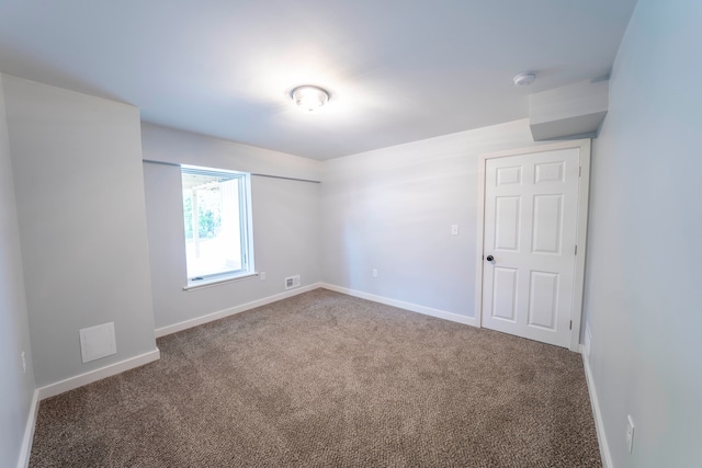 26015 E Huron River Dr, Flat Rock, MI 48134 - carpeted empty room with baseboards and a smoke detector