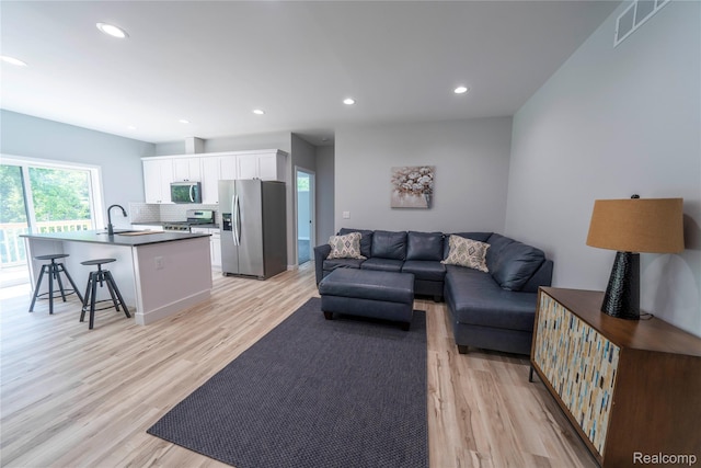 26015 E Huron River Dr, Flat Rock, MI 48134 - living area featuring light wood-type flooring and recessed lighting