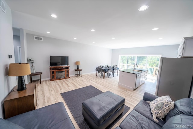 26015 E Huron River Dr, Flat Rock, MI 48134 - living room with light wood-type flooring, recessed lighting, and baseboards