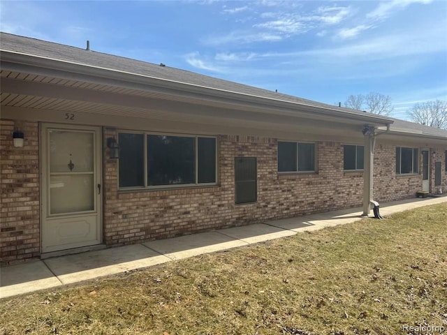 16050 Holz Dr Unit 52, Southgate, MI 48195 - rear view of house with brick siding and roof with shingles