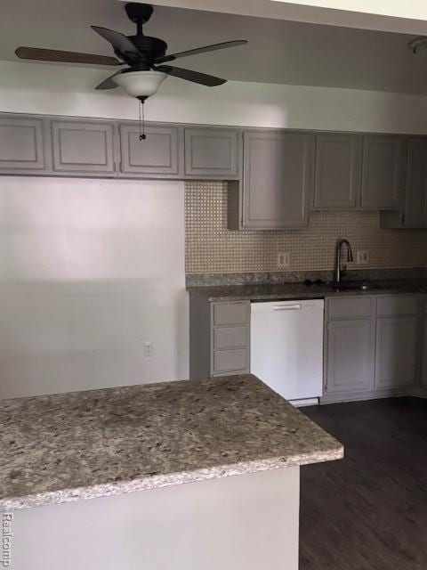 16050 Holz Dr Unit 52, Southgate, MI 48195 - kitchen with white dishwasher, gray cabinets, a ceiling fan, light stone countertops, and dark wood-type flooring