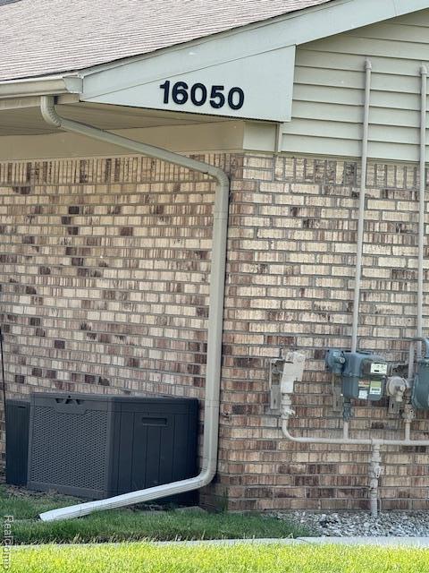 16050 Holz Dr Unit 52, Southgate, MI 48195 - exterior view of brick siding and central air condition unit