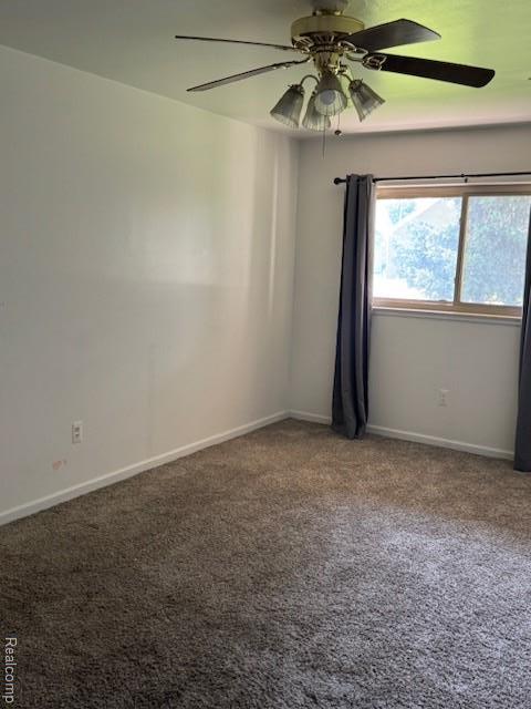 16050 Holz Dr Unit 52, Southgate, MI 48195 - empty room featuring carpet floors, a ceiling fan, and baseboards