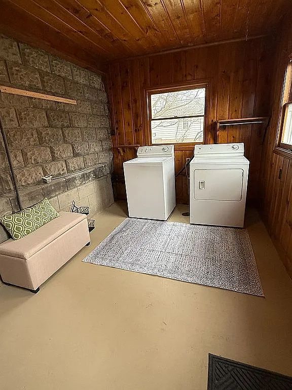 42 S Main St, Elkton, MI 48731 - clothes washing area with laundry area, wooden ceiling, separate washer and dryer, wooden walls, and plenty of natural light