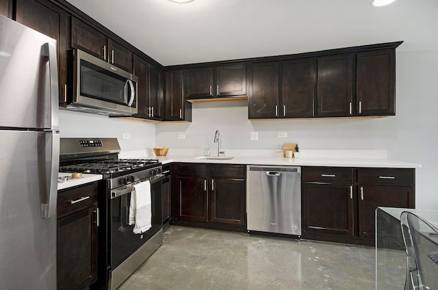 3320 Spinnaker Ln Unit 2E, Detroit, MI 48207 - kitchen featuring stainless steel appliances, a sink, finished concrete flooring, dark brown cabinets, and light countertops