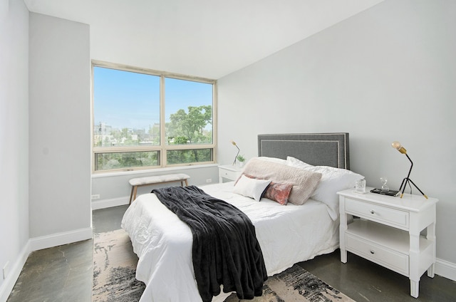 3320 Spinnaker Ln Unit 2E, Detroit, MI 48207 - bedroom featuring finished concrete floors, baseboards, and a view of city