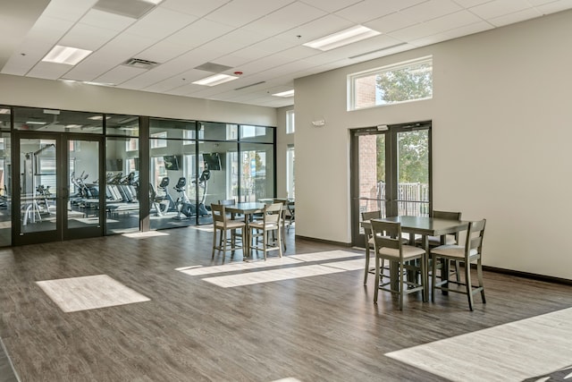 3320 Spinnaker Ln Unit 2E, Detroit, MI 48207 - dining space with wood finished floors, baseboards, french doors, a high ceiling, and a drop ceiling