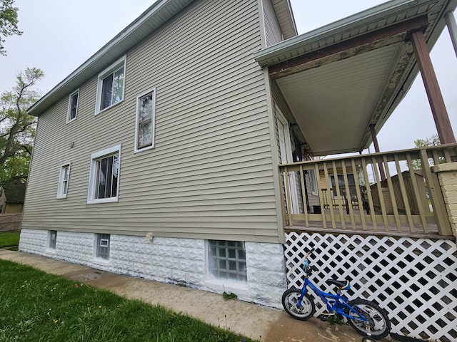 view of side of home featuring a wooden deck