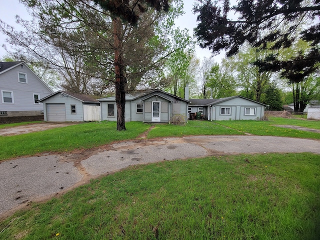 8558 Messmore Rd, Shelby Twp, MI 48317 - view of front of property with driveway, an outdoor structure, a front lawn, and a garage