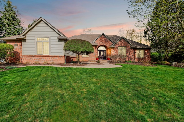 single story home with brick siding and a front lawn