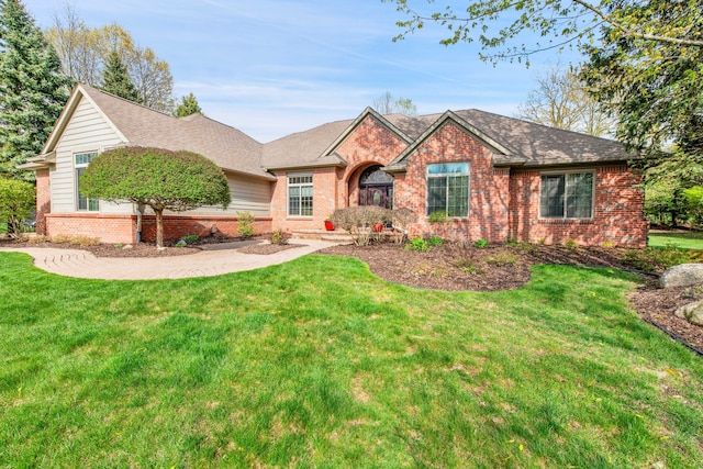 single story home with brick siding, a front yard, and roof with shingles
