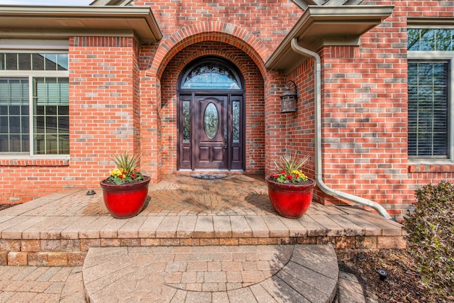 property entrance with brick siding