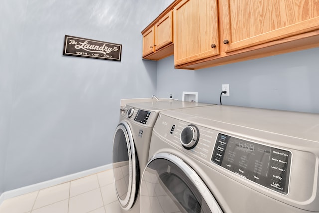 washroom with cabinet space, independent washer and dryer, tile patterned floors, and baseboards