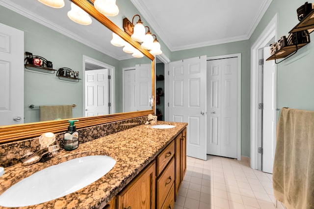 full bath with crown molding, double vanity, tile patterned floors, and baseboards