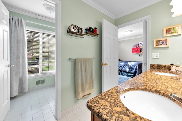 bathroom featuring ornamental molding, tile patterned flooring, double vanity, baseboards, and connected bathroom