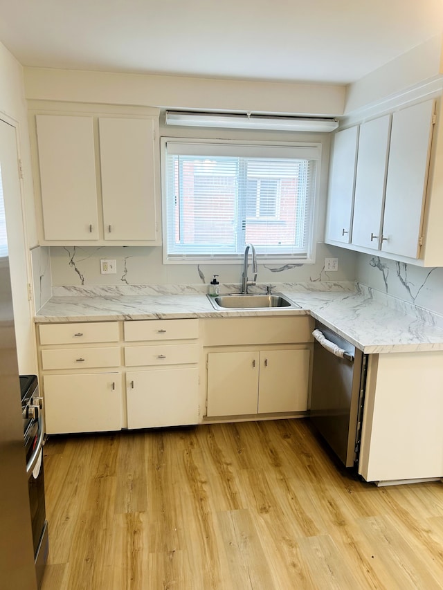 30101 Matthew St, Westland, MI 48186 - kitchen featuring appliances with stainless steel finishes, a sink, light wood-style flooring, and white cabinetry