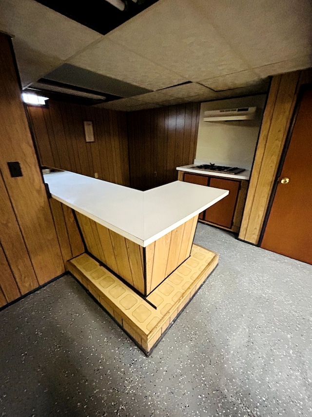 30101 Matthew St, Westland, MI 48186 - bar area featuring a paneled ceiling, wood walls, gas cooktop, and under cabinet range hood