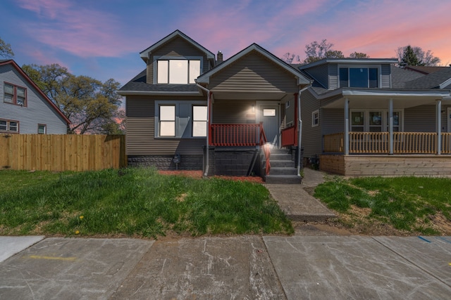 bungalow with a porch and fence