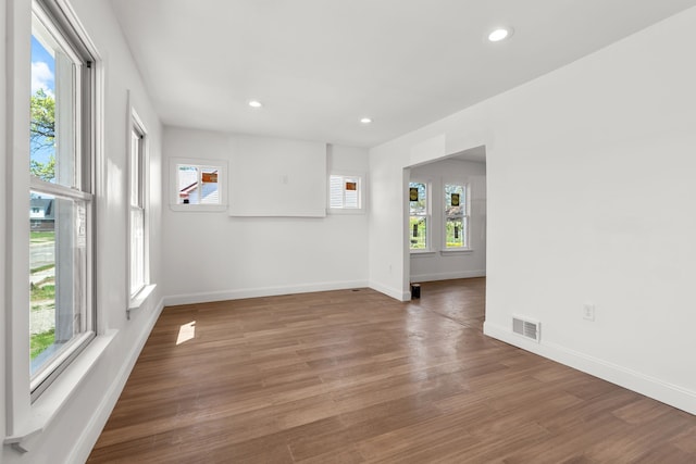 unfurnished room with recessed lighting, baseboards, and wood finished floors