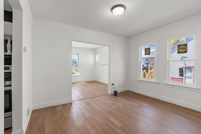 empty room with light wood-style floors and baseboards