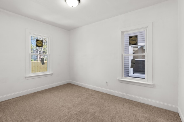 spare room with carpet and baseboards
