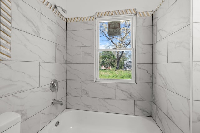 bathroom featuring toilet and shower / tub combination