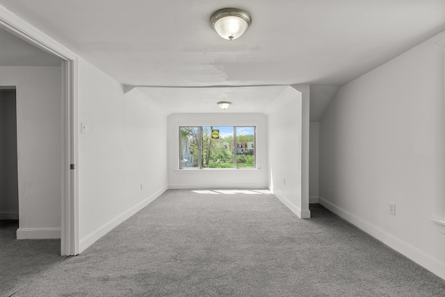 spare room featuring carpet and baseboards