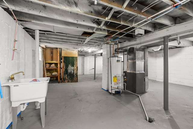 unfinished below grade area featuring gas water heater, heating unit, and a sink