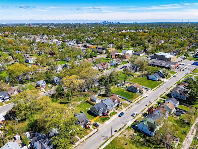 aerial view of property and surrounding area featuring nearby suburban area