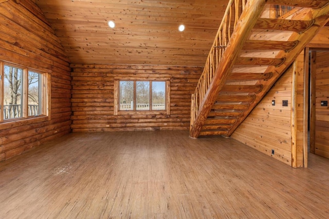 bonus room with lofted ceiling, a healthy amount of sunlight, and wood finished floors
