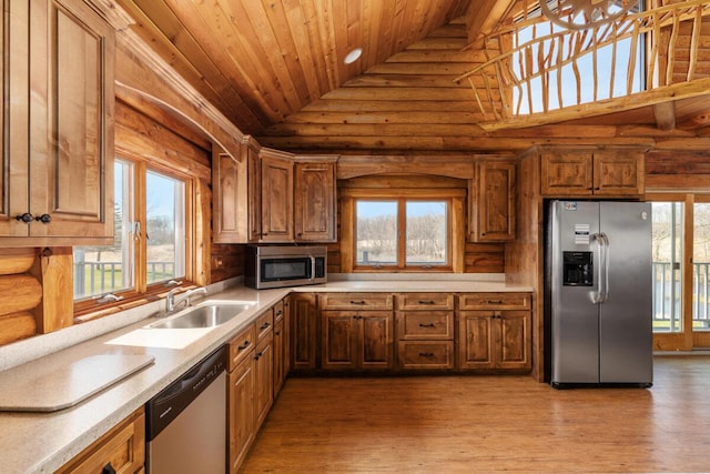 11840 Schreiner Rd, Bellevue, MI 49021 - kitchen featuring a sink, stainless steel appliances, high vaulted ceiling, wood ceiling, and rustic walls